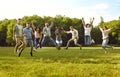 Group of a young happy smiling people friends jumping in the summer park. Royalty Free Stock Photo