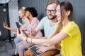 Group of young people with gadgets indoors Royalty Free Stock Photo