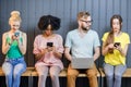 Group of young people with gadgets indoors Royalty Free Stock Photo