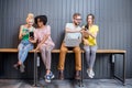 Group of young people with gadgets indoors Royalty Free Stock Photo
