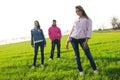 Group of young people on a green field