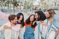 Group of young people having fun together, happy men giving their girlfriends a piggyback ride, enjoying with their best Royalty Free Stock Photo