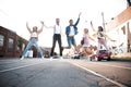 Group of young people having fun together outdoors in urban background. Royalty Free Stock Photo