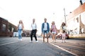 Group of young people having fun together outdoors in urban background. Royalty Free Stock Photo