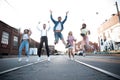 Group of young people having fun together outdoors in urban background. Royalty Free Stock Photo