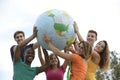 Group of young people holding a globe earth Royalty Free Stock Photo