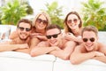 Group Of Young People On Holiday Relaxing By Swimming Pool Royalty Free Stock Photo