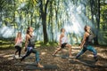 Group of young people keep in shape exercising in forest Royalty Free Stock Photo