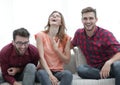 Group of young people laughing and sitting on the couch Royalty Free Stock Photo