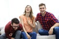 Group of young people laughing and sitting on the couch Royalty Free Stock Photo