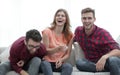 Group of young people laughing and sitting on the couch Royalty Free Stock Photo