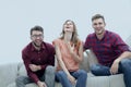 Group of young people laughing and sitting on the couch Royalty Free Stock Photo