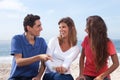 Group of young people looking at pictures on smartphone Royalty Free Stock Photo