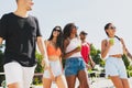 Group of young people, men and women resting on the beach, drinking cool drinks, having fun, sunbathing Royalty Free Stock Photo