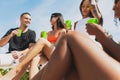 Group of young people, men and women resting, drinking cool drinks, having fun, sunbathing on bright summer day Royalty Free Stock Photo