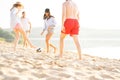 Group of young people playing with ball at the beach. Young friends enjoying summer holidays on a sandy beach Royalty Free Stock Photo