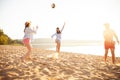 Group of young people playing with ball at the beach. Young friends enjoying summer holidays on a sandy beach Royalty Free Stock Photo