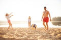 Group of young people playing with ball at the beach. Young friends enjoying summer holidays on a sandy beach Royalty Free Stock Photo