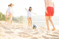 Group of young people playing with ball at the beach. Young friends enjoying summer holidays on a sandy beach Royalty Free Stock Photo