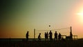 Group of young people playing volleyball on the beach. Royalty Free Stock Photo