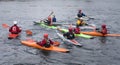 Group of young people practicing water sports with canoes.