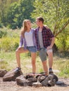 Group of young people preparing picnic outside. They enjoy nature and each other. Royalty Free Stock Photo