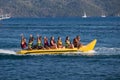 Group of young people riding banana boat Royalty Free Stock Photo