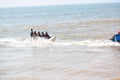 Group of young people riding banana boat water sport.Anjuna beach,Goa,India.14 December 2019 Royalty Free Stock Photo