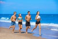 Group of young people running in the beach Royalty Free Stock Photo