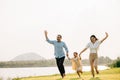 A group of young people running and having fun in a green park on a sunny day Royalty Free Stock Photo