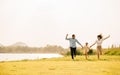 A group of young people running and having fun in a green park on a sunny day Royalty Free Stock Photo