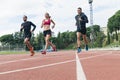 Group of young people running on the track field Royalty Free Stock Photo