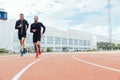 Group of young people running on the track field Royalty Free Stock Photo