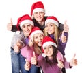 Group young people in santa hat show thumbs up. Royalty Free Stock Photo