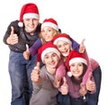 Group young people in santa hat show thumbs up. Royalty Free Stock Photo