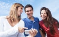 Group of young people showing pictures at phone Royalty Free Stock Photo