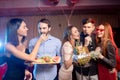 Group of young people singing into microphone at party,celebrating birthday, karaoke Royalty Free Stock Photo