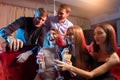 Group of young people singing into microphone at party,celebrating birthday, karaoke Royalty Free Stock Photo