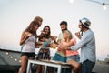 Group of young people sitting around and eating pizza Royalty Free Stock Photo