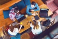 Group of young people sitting at a cafe, talking and enjoying Royalty Free Stock Photo