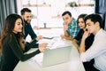 Group of young people sitting at a cafe, talking and enjoying, Royalty Free Stock Photo