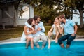 Group of young people sitting on the swimming pool. Day with friends Royalty Free Stock Photo