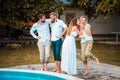 Young people sitting on the swimming pool. Two women sharing secret Royalty Free Stock Photo