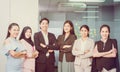 Group of young people smiling and arms crossed in office workplace, Successful business team standing and looking at camera with Royalty Free Stock Photo