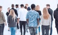 a group of young people stand with their backs looking into the Royalty Free Stock Photo