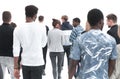 A group of young people stand with their backs looking into the distance Royalty Free Stock Photo