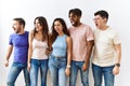 Group of young people standing together over isolated background angry and mad screaming frustrated and furious, shouting with Royalty Free Stock Photo