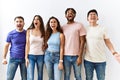 Group of young people standing together over isolated background angry and mad screaming frustrated and furious, shouting with Royalty Free Stock Photo