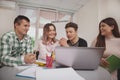 Group of young people studying together at college classroom