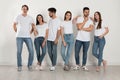 Group of young people in stylish jeans near  wall Royalty Free Stock Photo